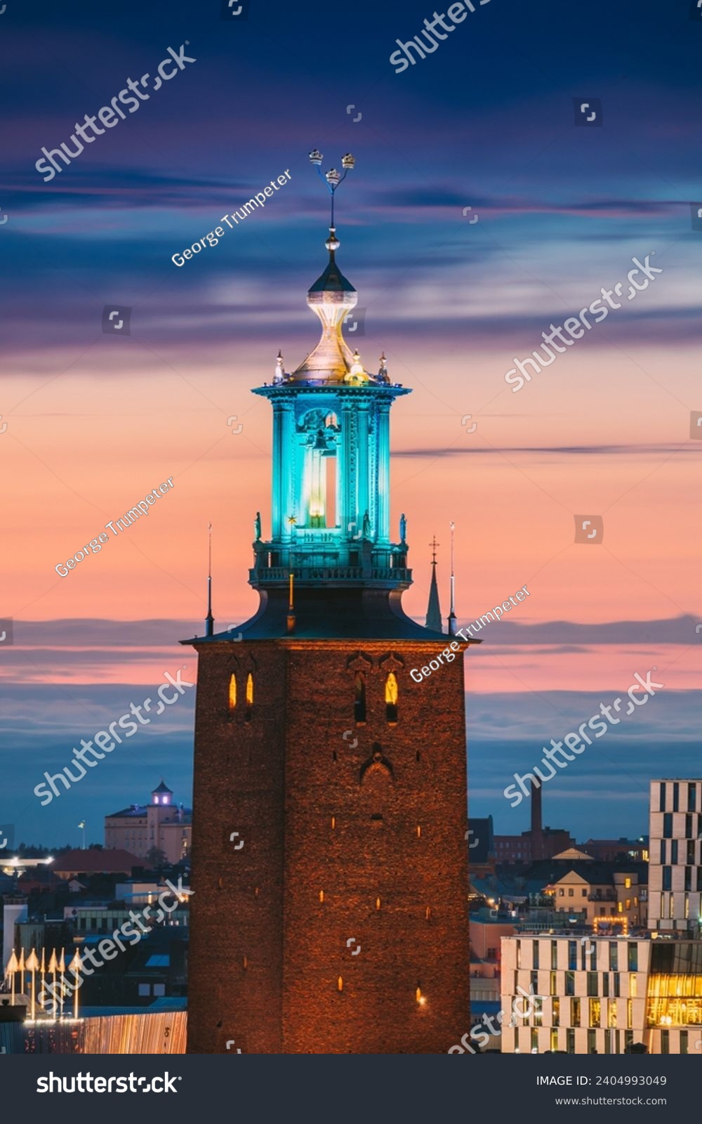 Stockholm, Sweden. Close View Of Famous Tower Of Stockholm City Hall. Popular Destination Scenic In Sunset Twilight Dusk Lights. Evening Lighting. #2404993049