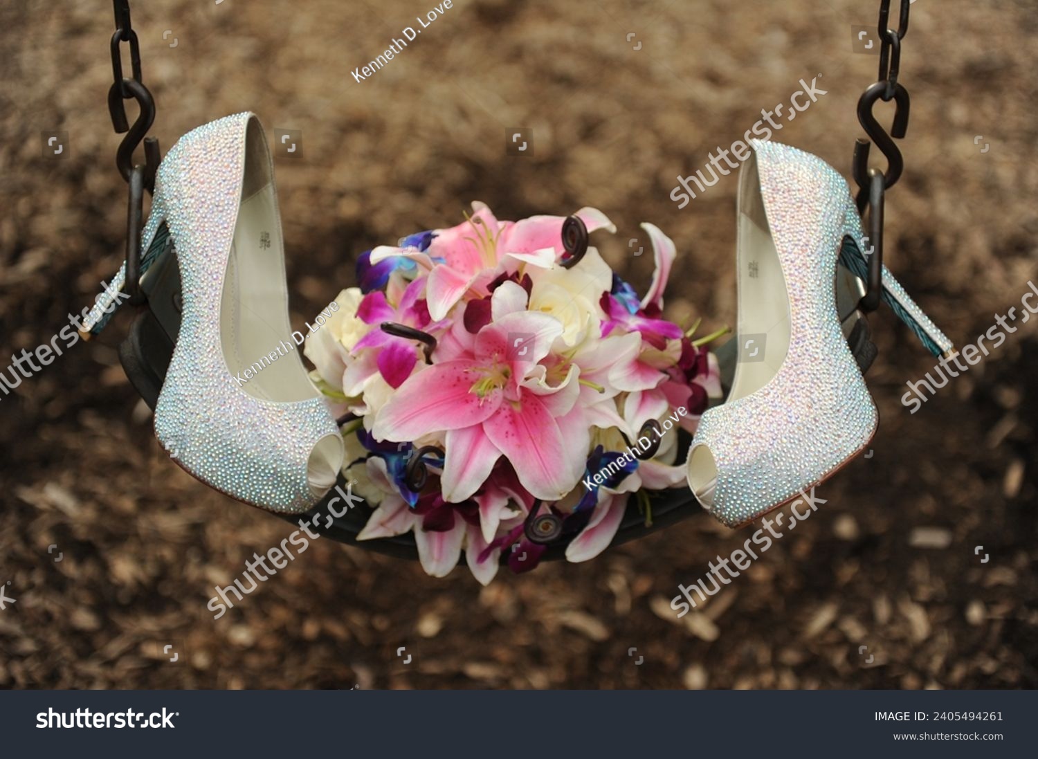 close up of wedding bouquet and white high heels sitting on swing at the park on wedding day #2405494261