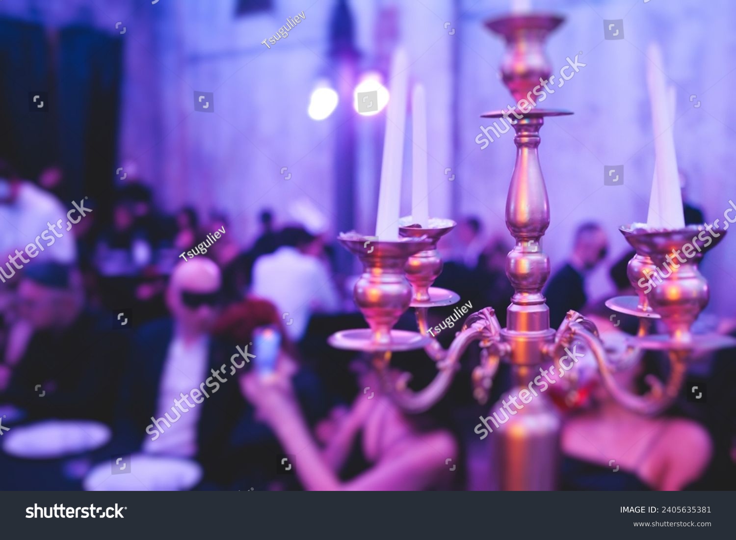Vintage retro brass candlesticks with candles burning, luxury event banquet table setting decoration in a restaurant hall, atmosphere with  a candleholder, candle fire with guests on masquerade party #2405635381