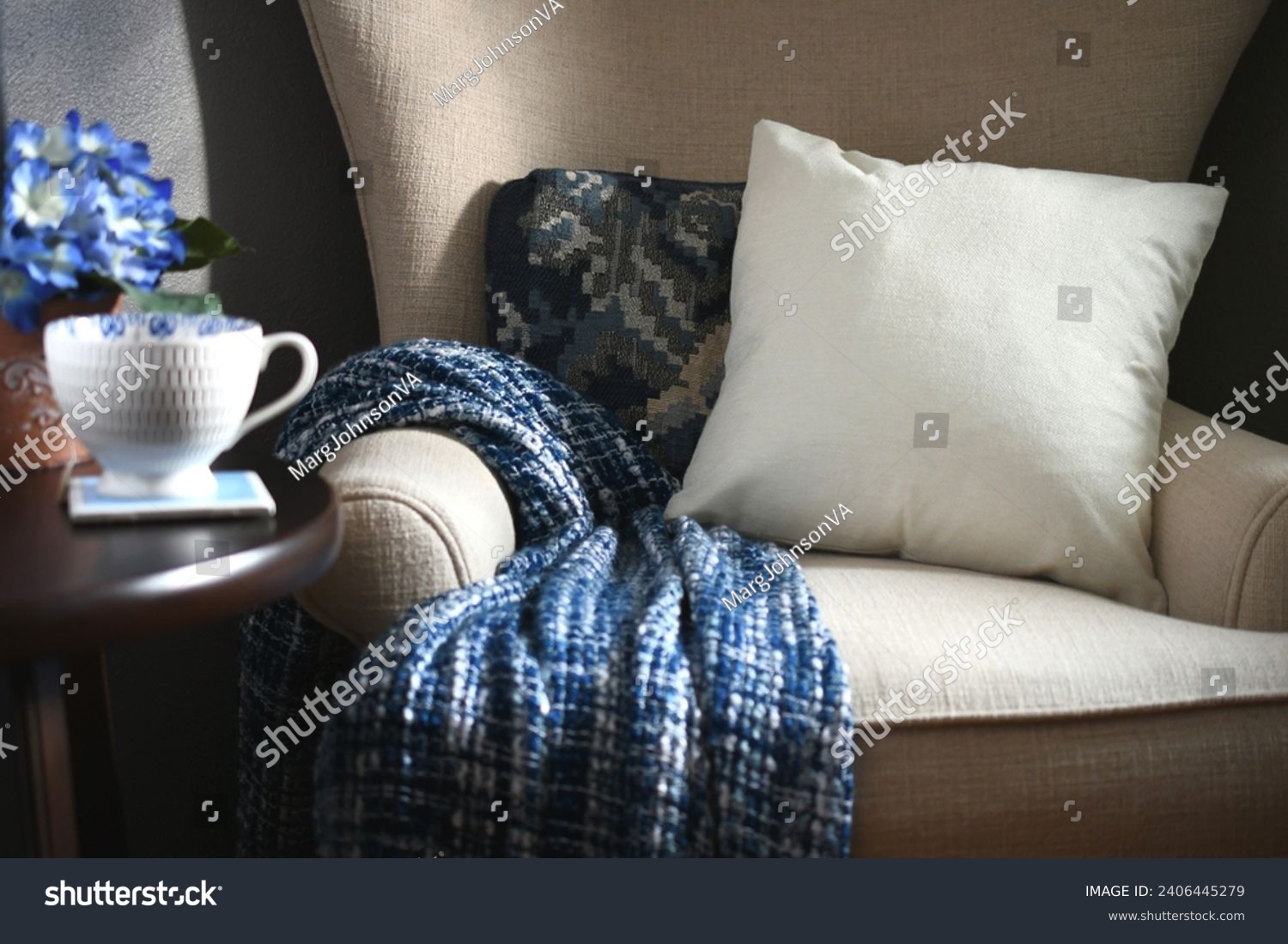 Plain canvas throw pillow suitable for mock up mockup on a chair with blue throw blanket - your design, message or logo #2406445279