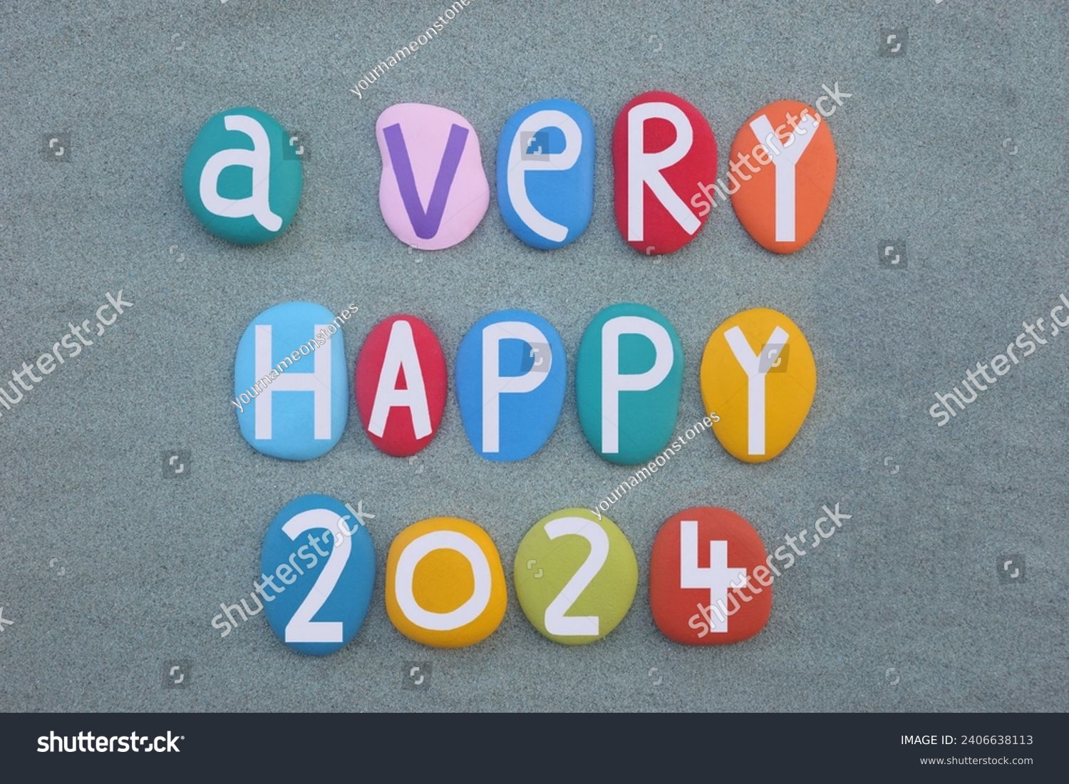 A very happy 2024 composed with hand painted multi colored stone letters and numbers over green sand #2406638113