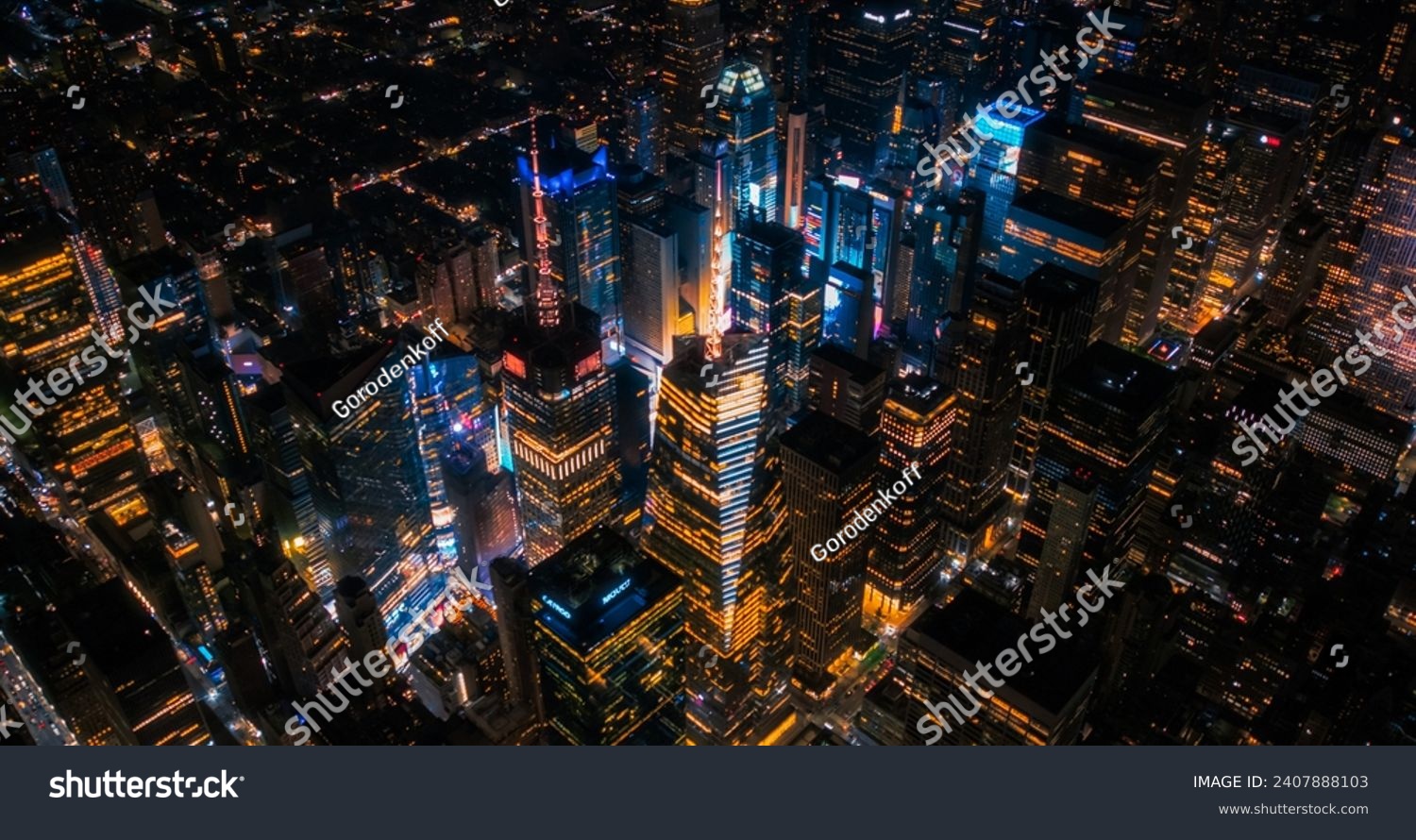 New York Concrete Jungle at Night. Aerial Photo from a Helicopter Tour Around the Center of the Big Apple. Scenes with Times Square District with Crowds of Tourists Enjoying Manhattan Nightlife #2407888103