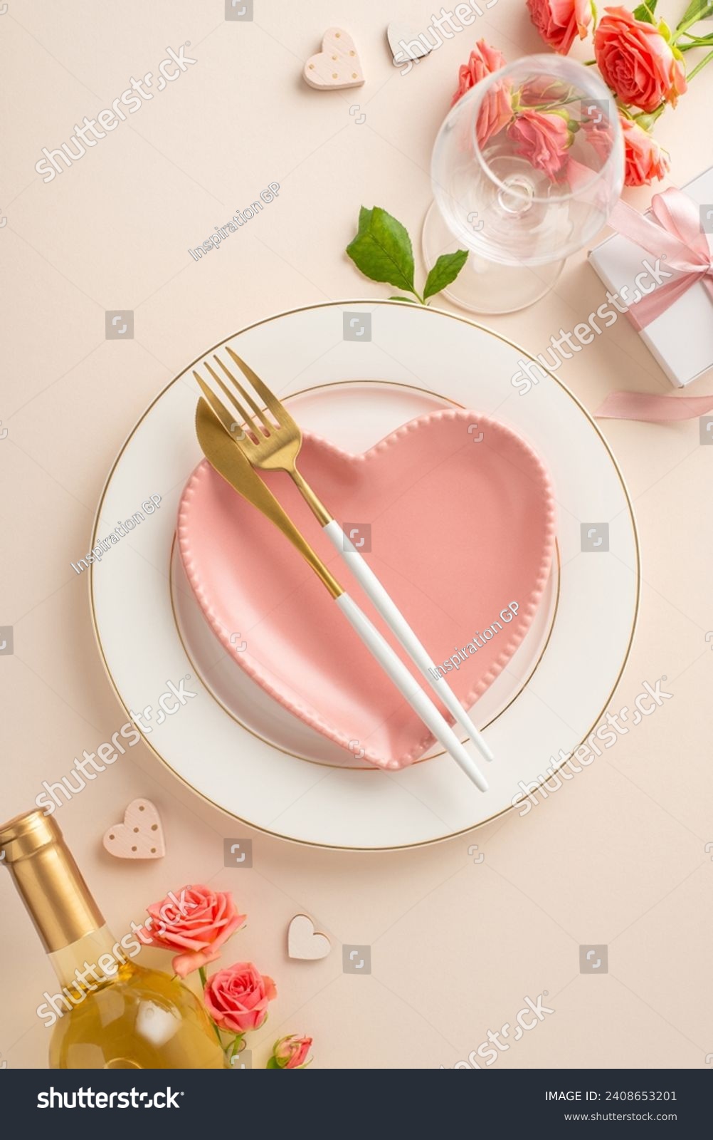 Elegant Date Night: vertical top-down view captures the essence of a romantic dinner setting. Heart-shaped plate, cutlery, white wine, roses, themed decor on pastel beige surface for heartfelt message #2408653201