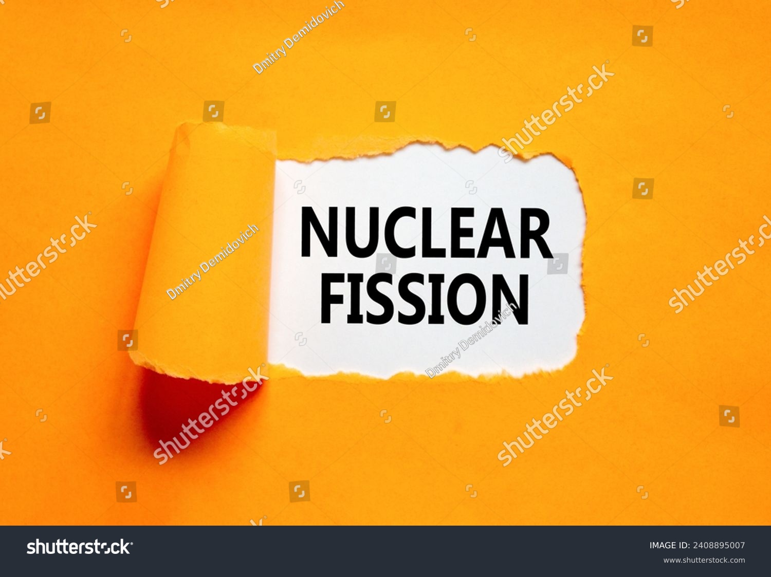Nuclear fission symbol. Concept words Nuclear fission on beautiful white paper. Beautiful orange paper background. Business science nuclear fission concept. Copy space. #2408895007
