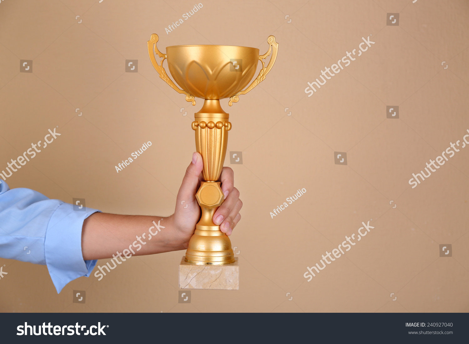Woman holding trophy cup on color background #240927040