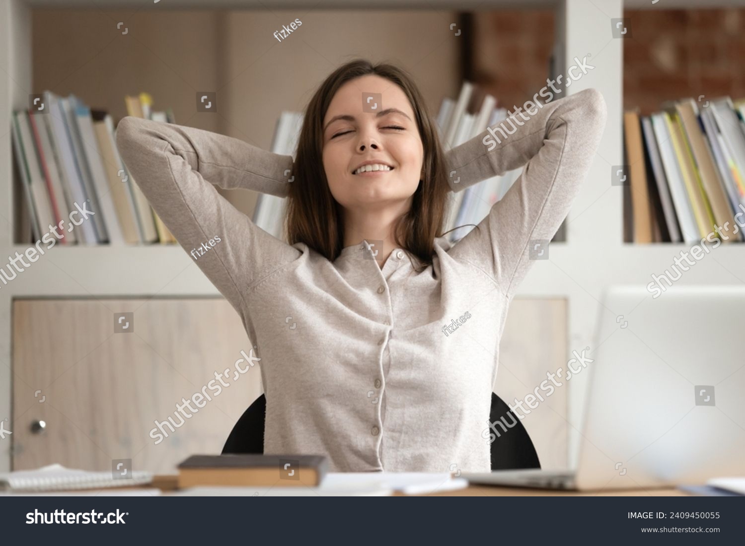 Calm Caucasian millennial female student lean back in chair at desk relax with eyes closed take break from studying, happy girl rest at workplace breathe fresh air enjoy peace, stress free concept #2409450055
