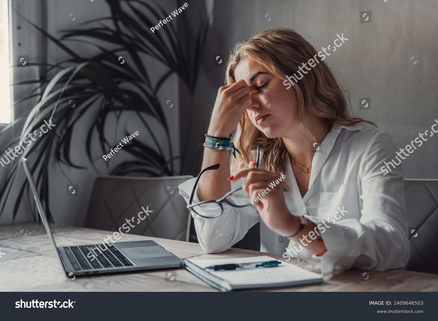 Stressed tired woman in pain having strong terrible headache attack after computer laptop study, fatigued exhausted girl suffering from chronic migraine massaging temples to relieve head ache tension #2409646503