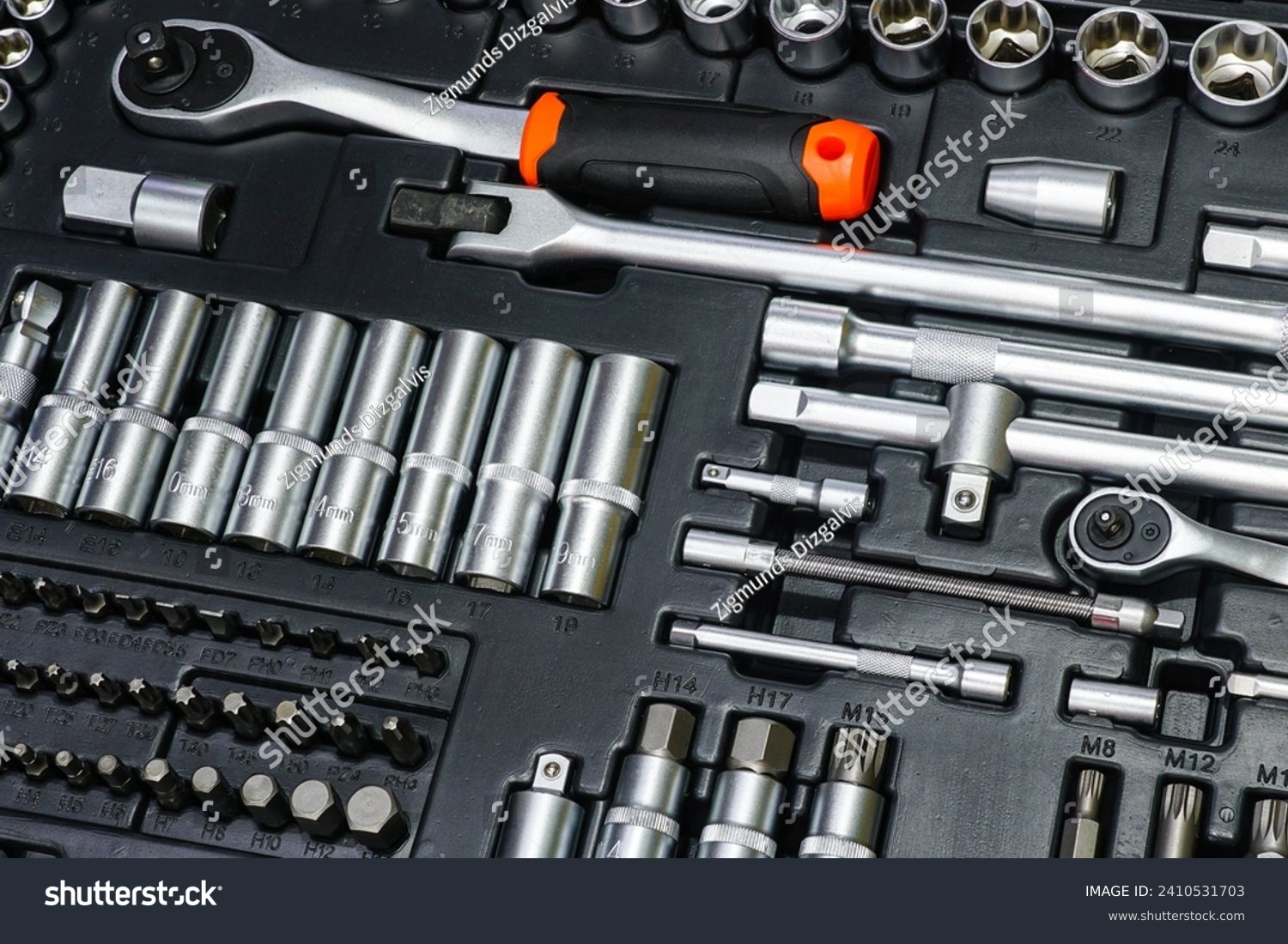 Tool box, tool kit closeup with set of hex, torx and screwdriver bits and ratchet wrench sockets #2410531703