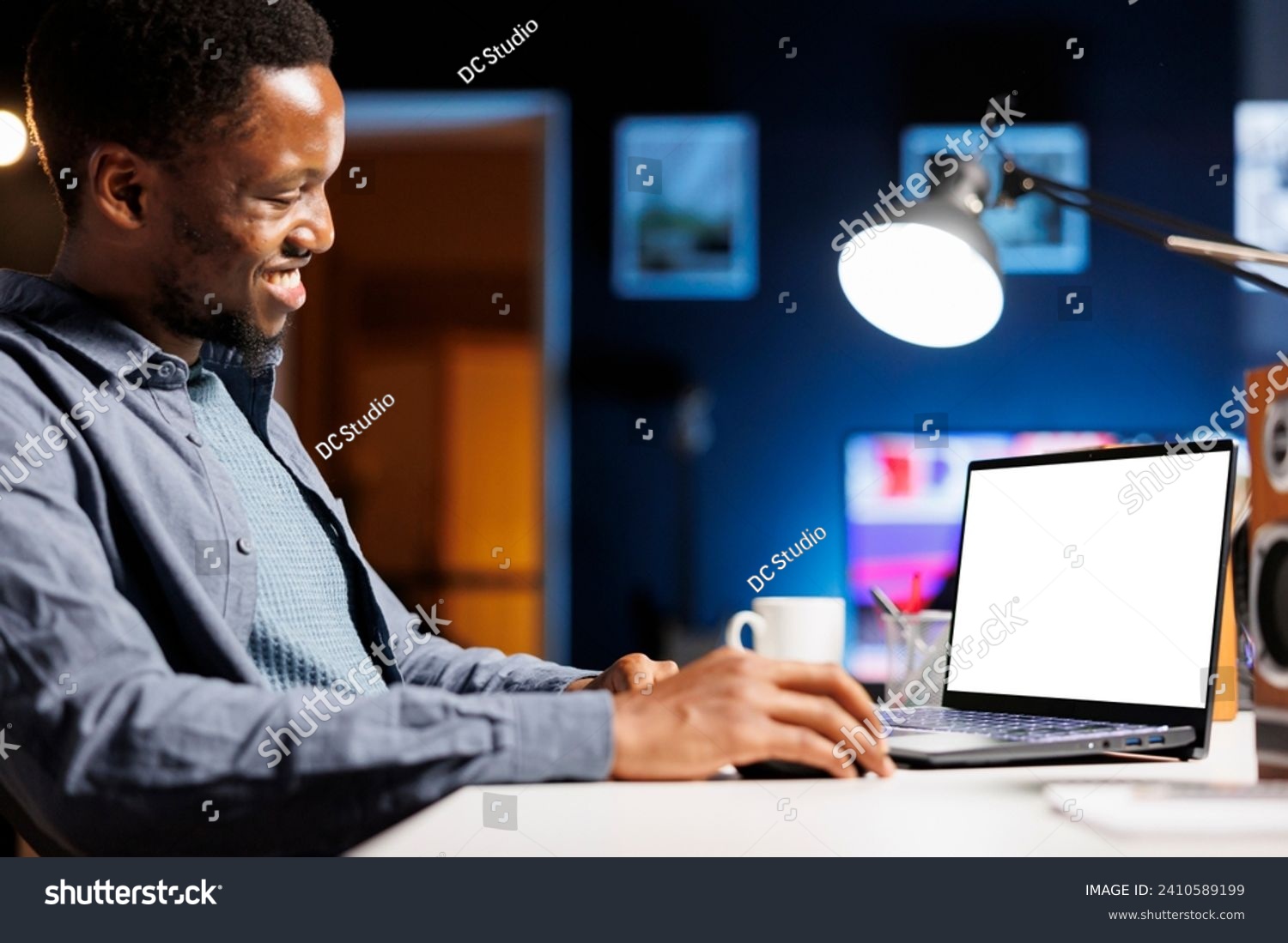 While telecommuting, self employed individual glances at empty layout on laptop and builds his abilities at home. Employee enjoying self education online class package, personal program. #2410589199
