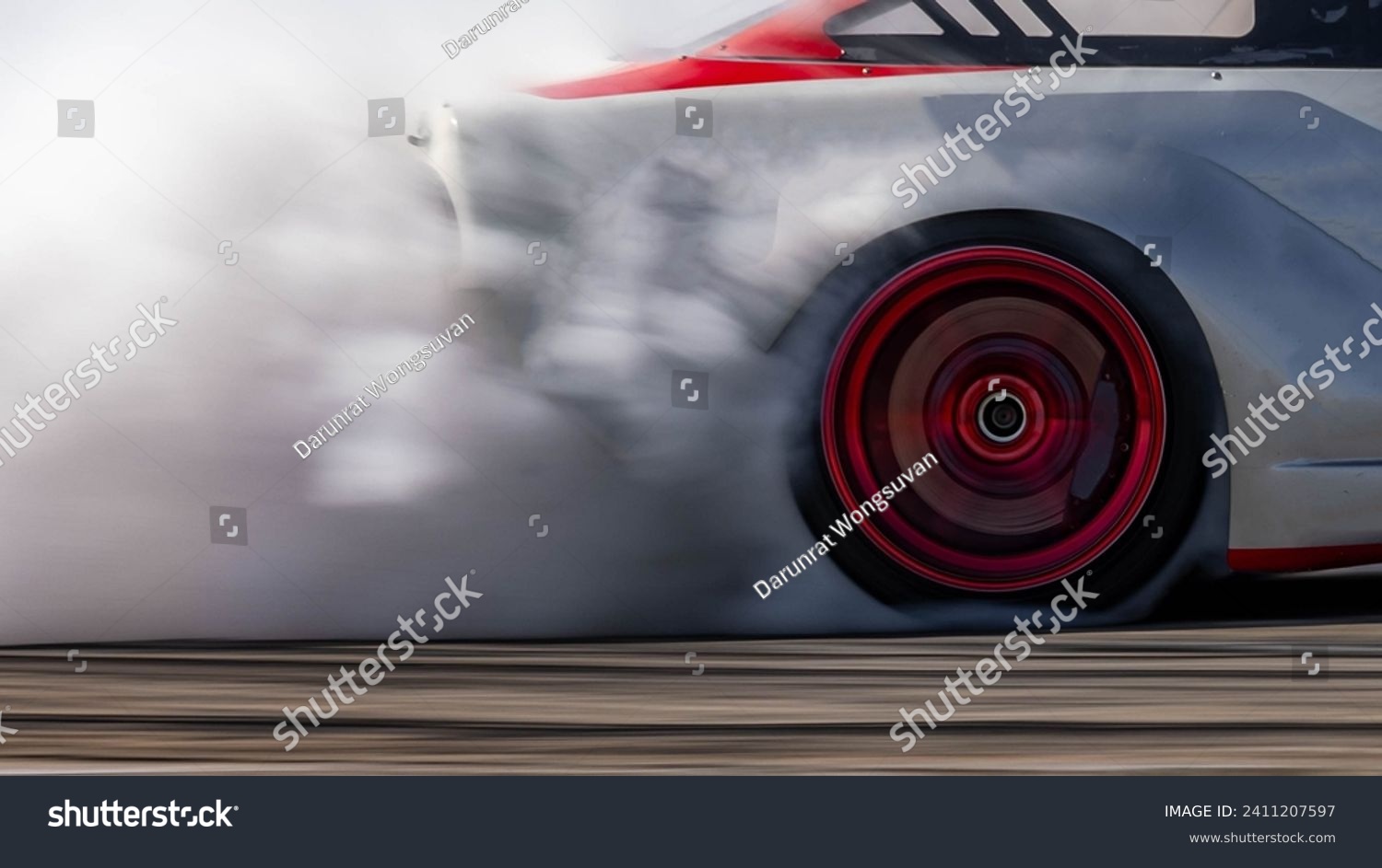 Blurred car drifting diffusion race drift car with lots of smoke from burning tires on speed track, Professional driver drifting car on race track with smoke. #2411207597