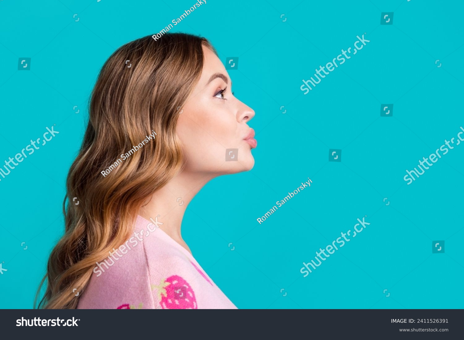 Side profile photo of young coquette girlfriend plump lips sending air kiss empty space learning flirt isolated on blue color background #2411526391