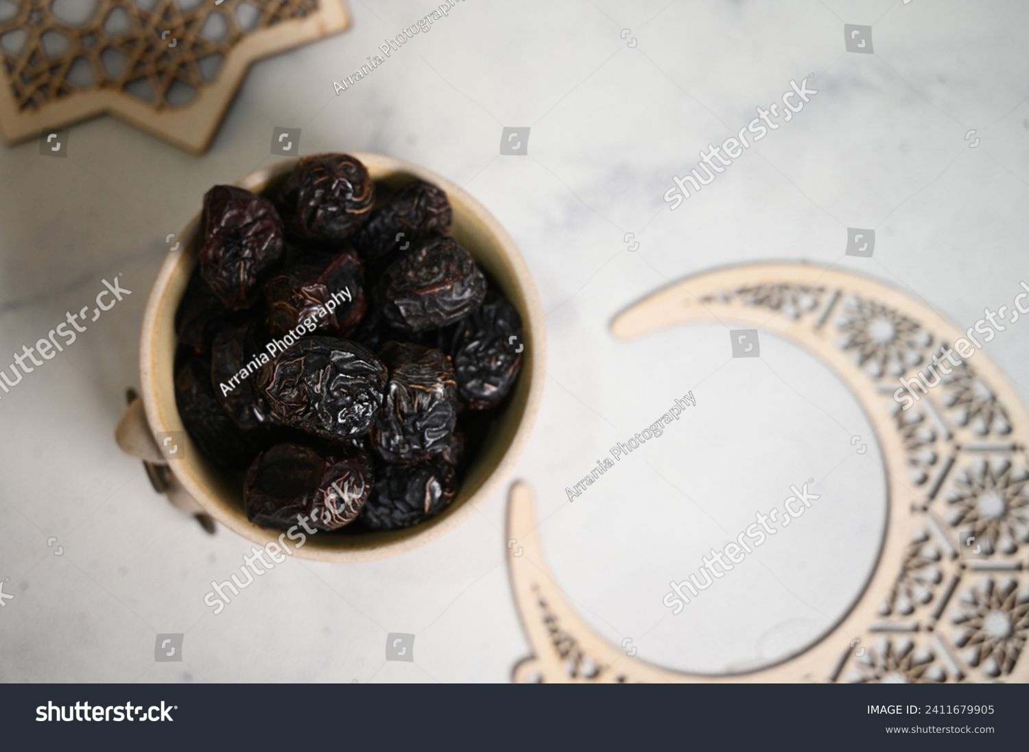 Kurma Ajwa, Ajwa Dates, served in ceramic bowl. Kurma Ajwa is one of the special fruit of Arabic.  Typical Food During Ramadan. Selective Focus. #2411679905