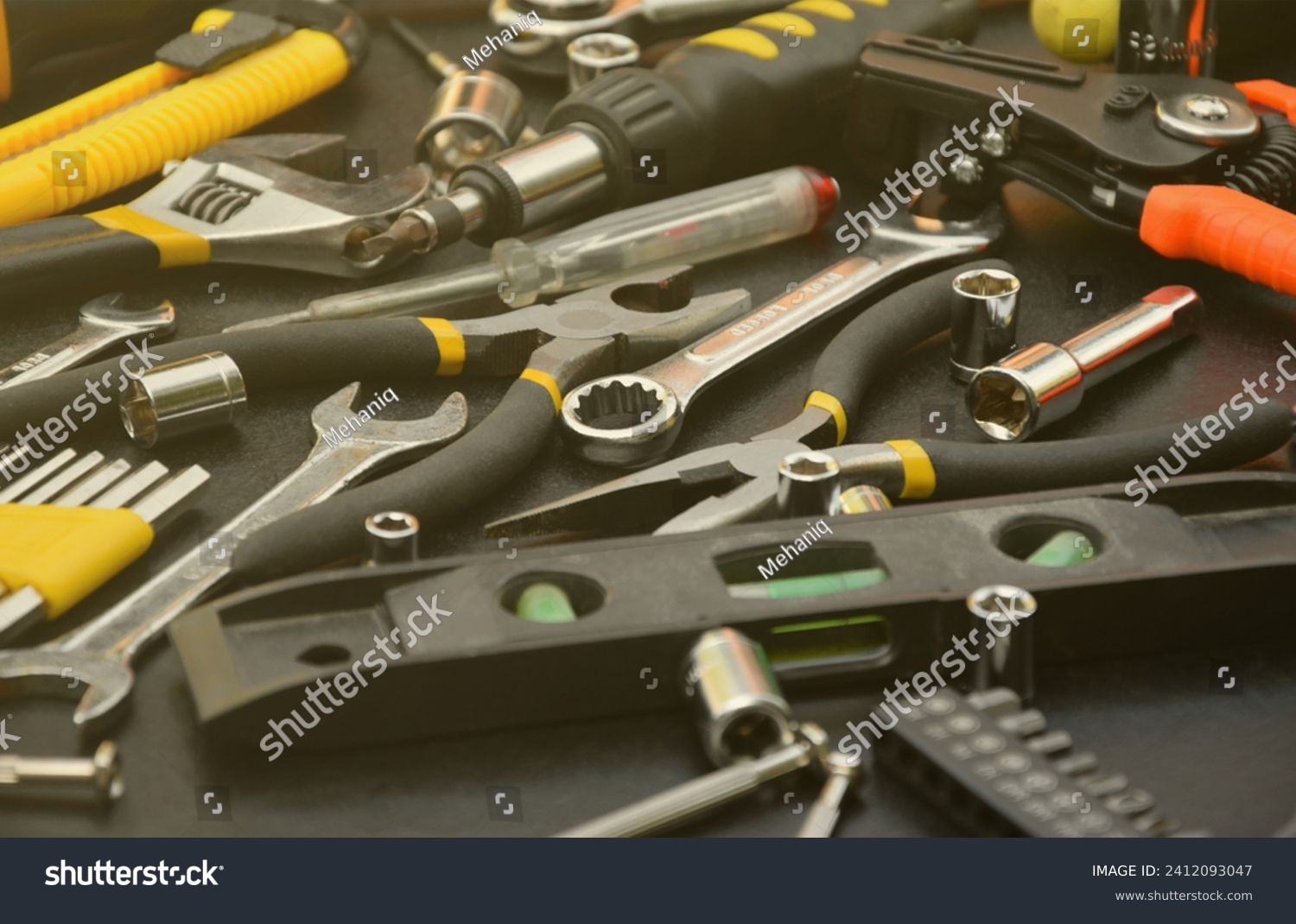 Handyman tool kit on black wooden table. Many wrenches and screwdrivers, pilers and other tools for any types of repair or construction works. Repairman tools set #2412093047