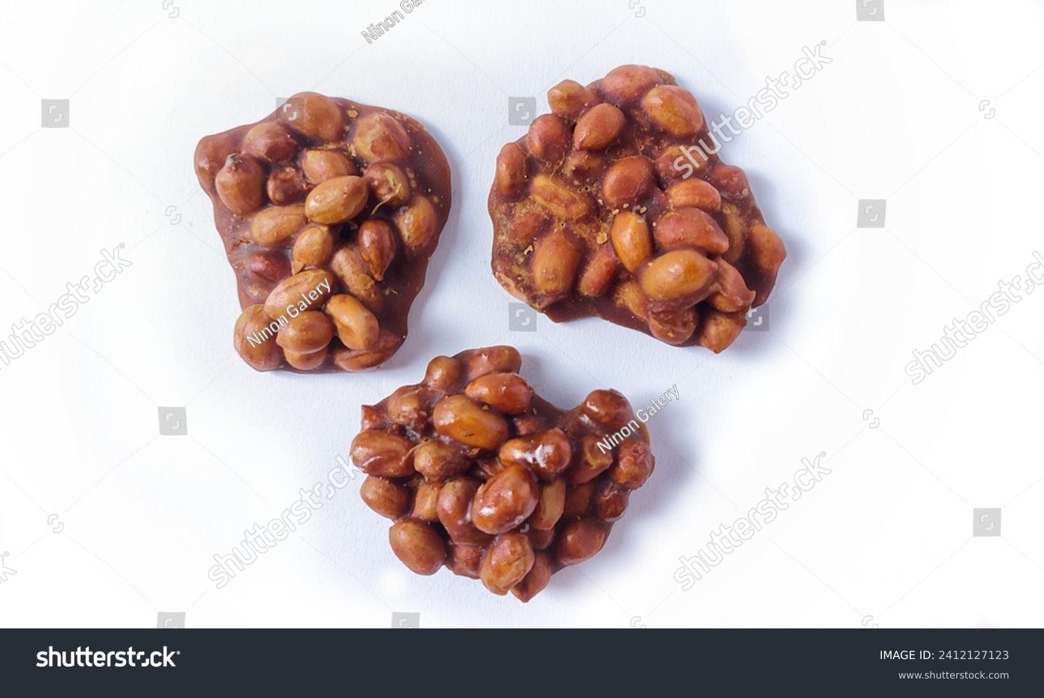 Top view of Ting-ting or Enting-enting or Ampyang isolated on white background. Traditional Indonesian sweet snack made from peanuts mixed with brown sugar. Clipping path.  #2412127123