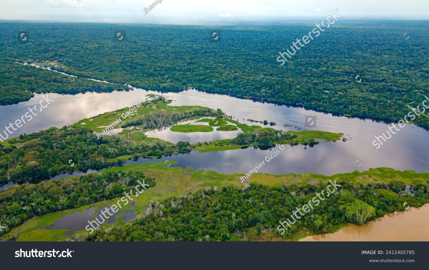 Aerial view of the lush Amazon rainforest, winding rivers, and serene lakes in Amazonas, Colombia #2412405785