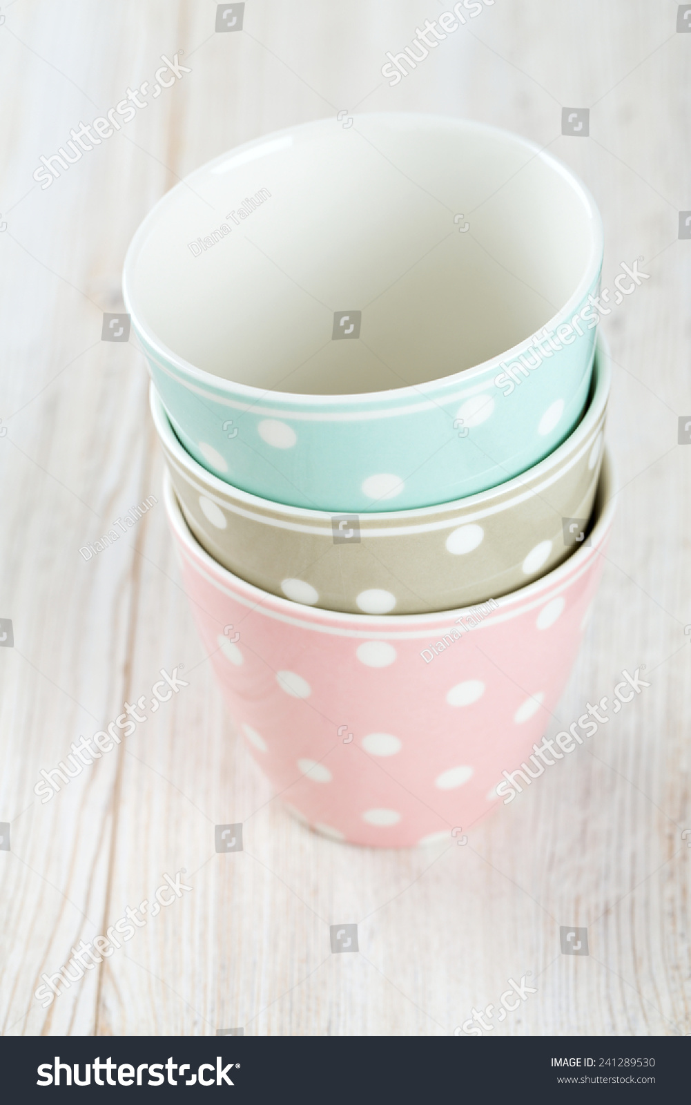 polka dot cups on wooden surface #241289530