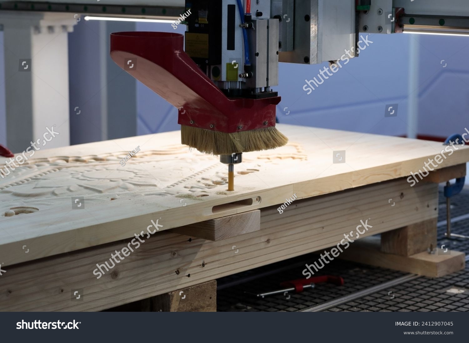 Wooden door manufacturing with CNC router machine. Selective focus. #2412907045