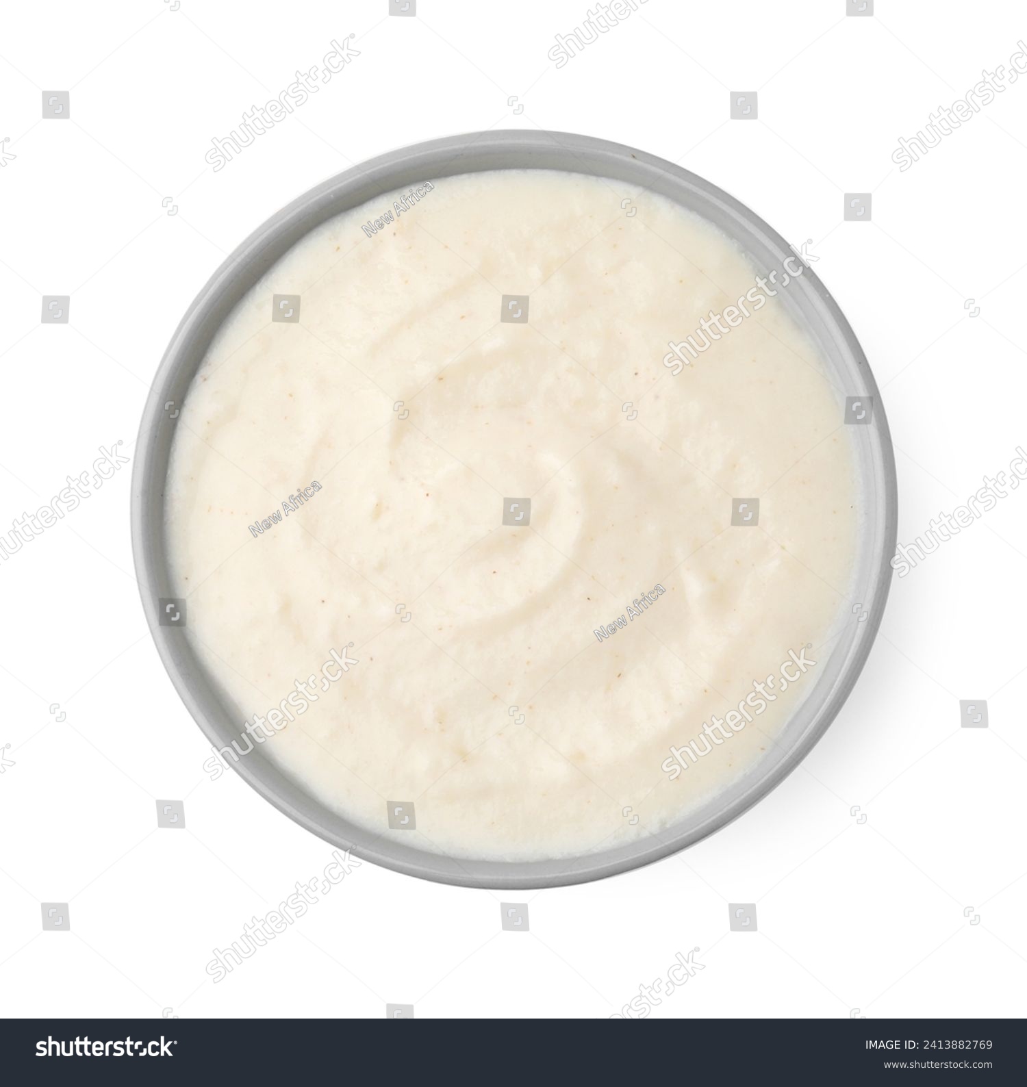 Delicious semolina pudding in bowl isolated on white, top view #2413882769