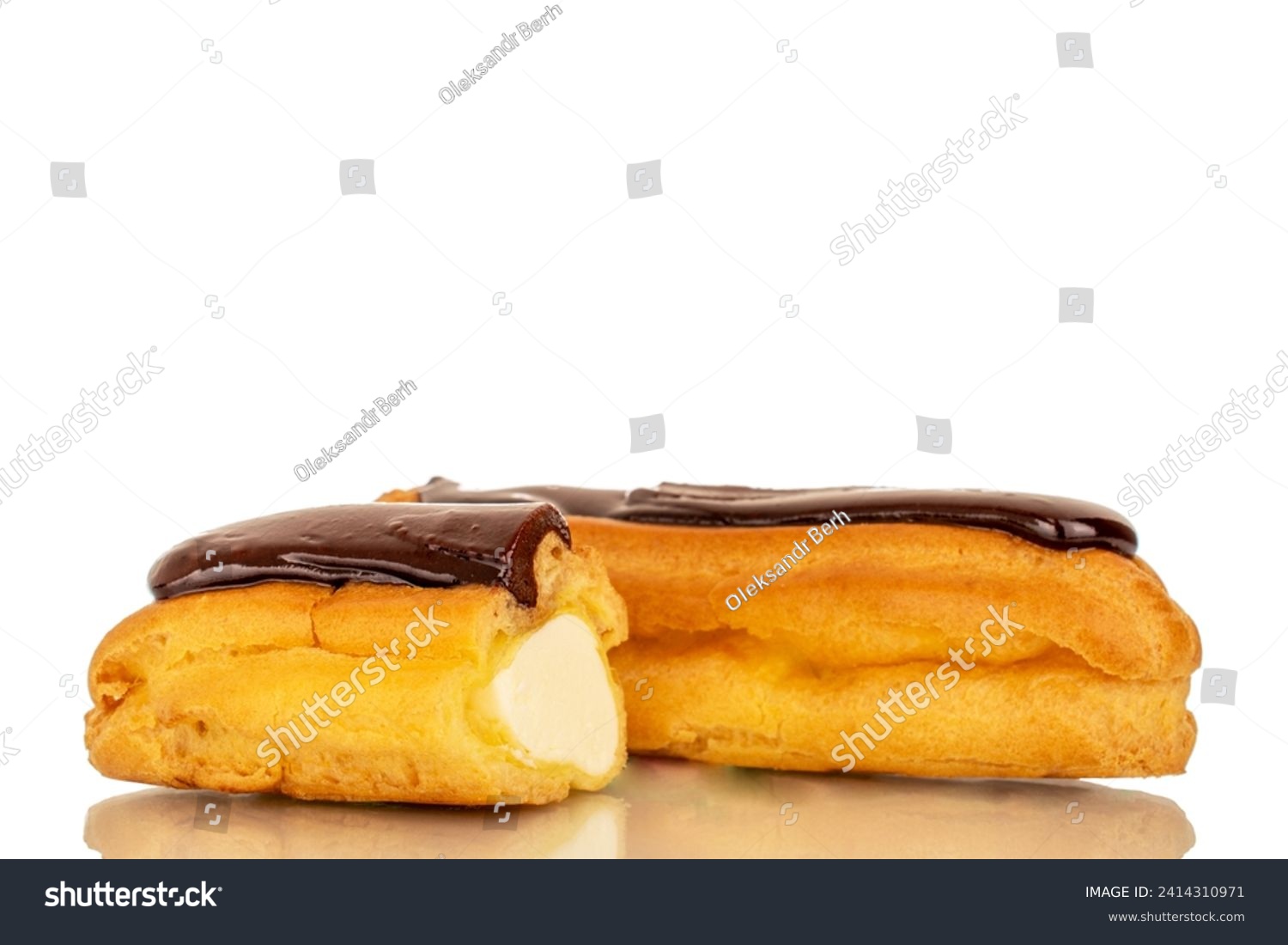 One whole and one half delicious chocolate eclair, close-up isolated on white. #2414310971