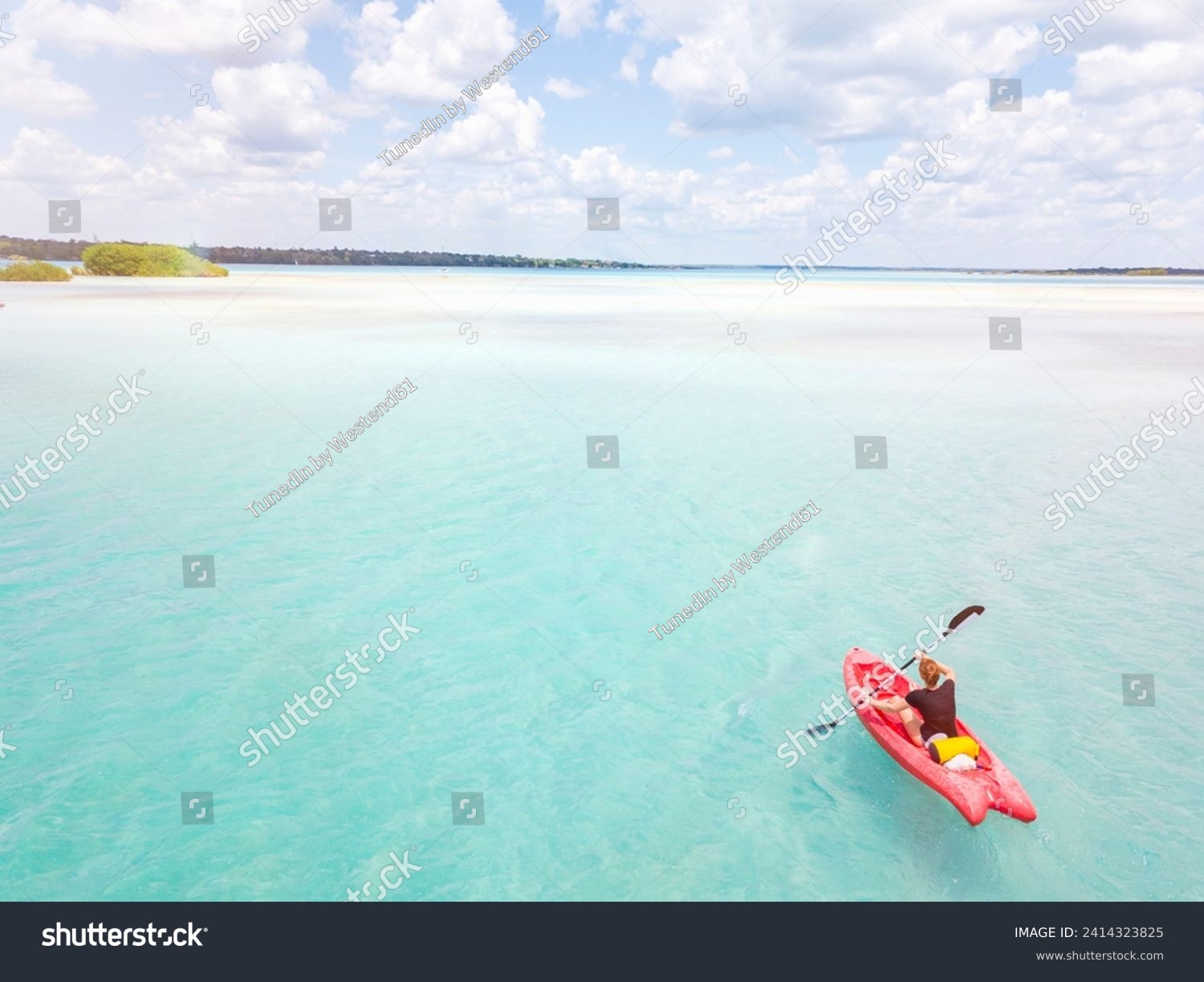 Mexiko- yucatan- quintana roo- bacalar- woman in kayak on the sea in turquoise water- drone image #2414323825