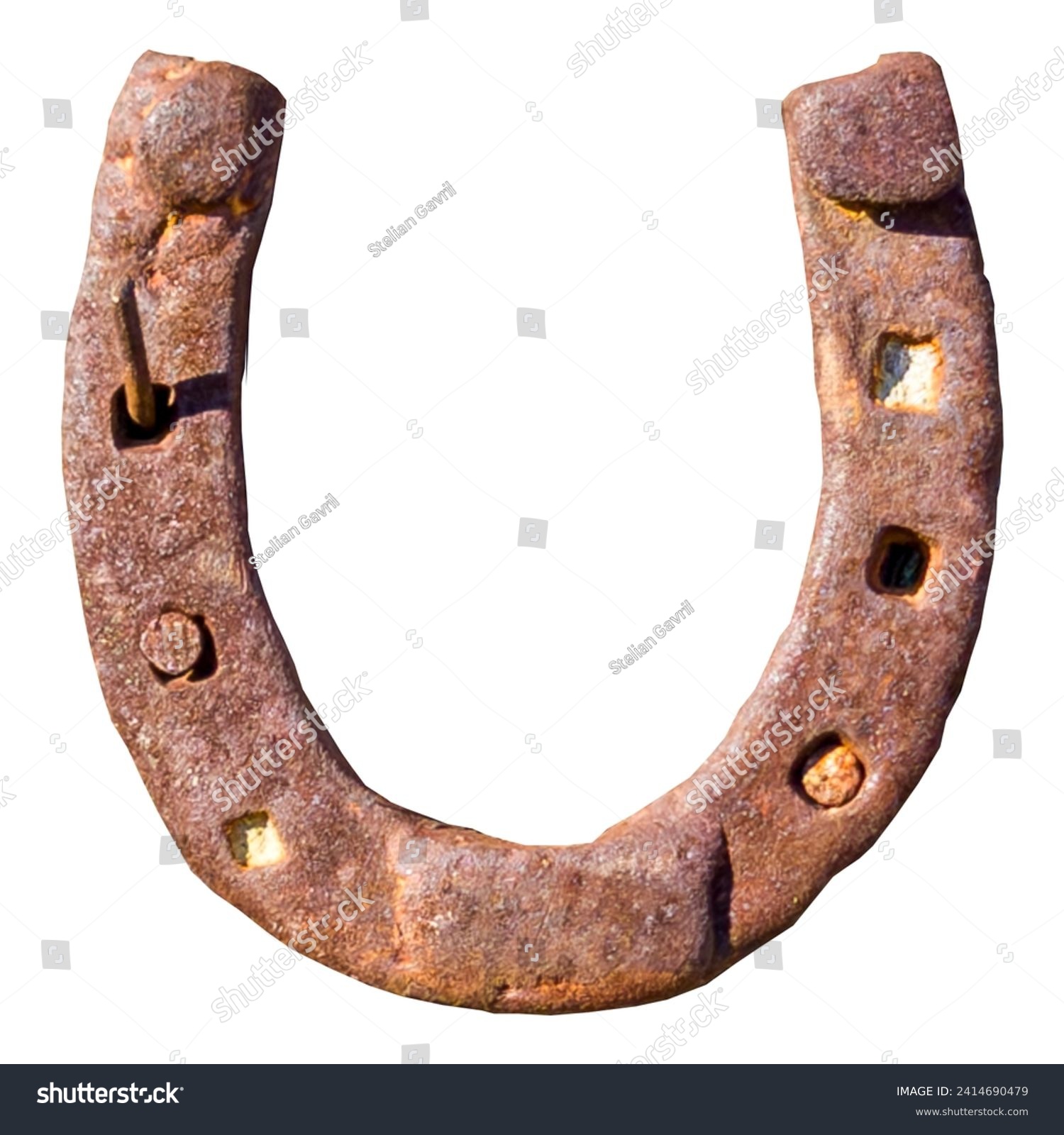 An old, rusted horseshoe on a white background, symbol of luck. The rust gives the object a nostalgic patina, while the white background accentuates the simplicity and elegance of the lucky symbol. #2414690479