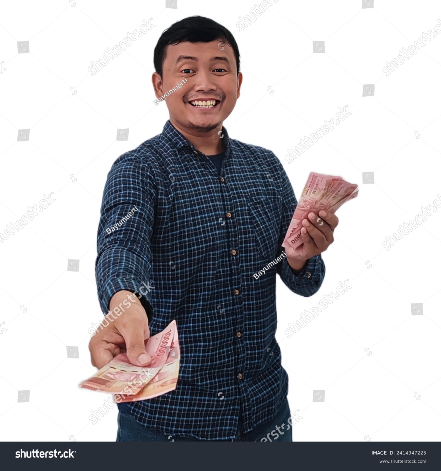 Smiling asian man holding money banknotes and pointing finger at camera, Expression of asian man holding money giving to you.  Asian man giving money for you. Man holding indonesian money rupiah.  #2414947225