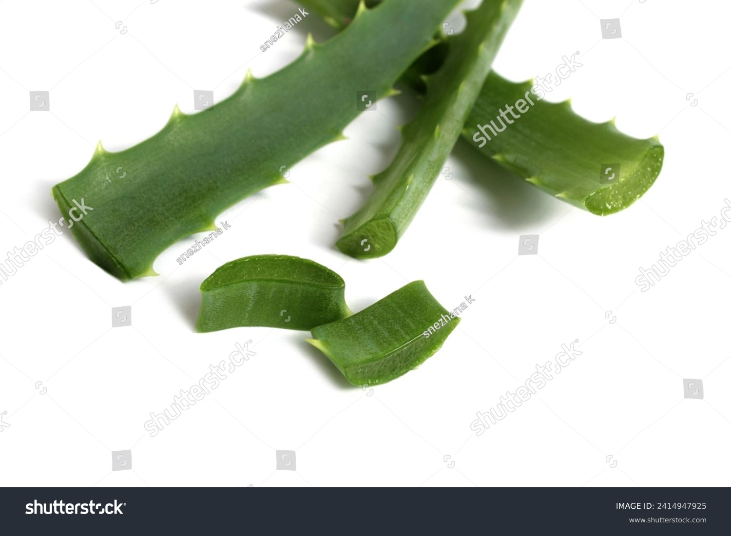 Several pieces of aloe leaves lie on a white background. #2414947925