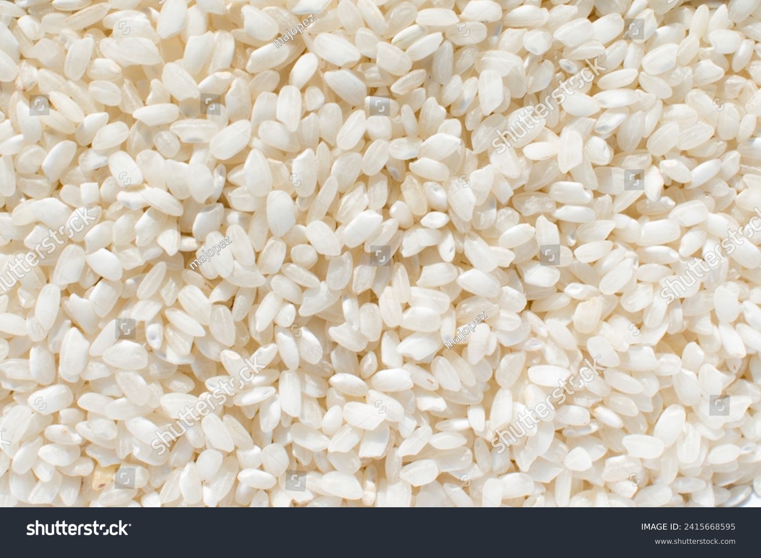 Uncooked organic white rice, background. Carbohydrate - food type  #2415668595