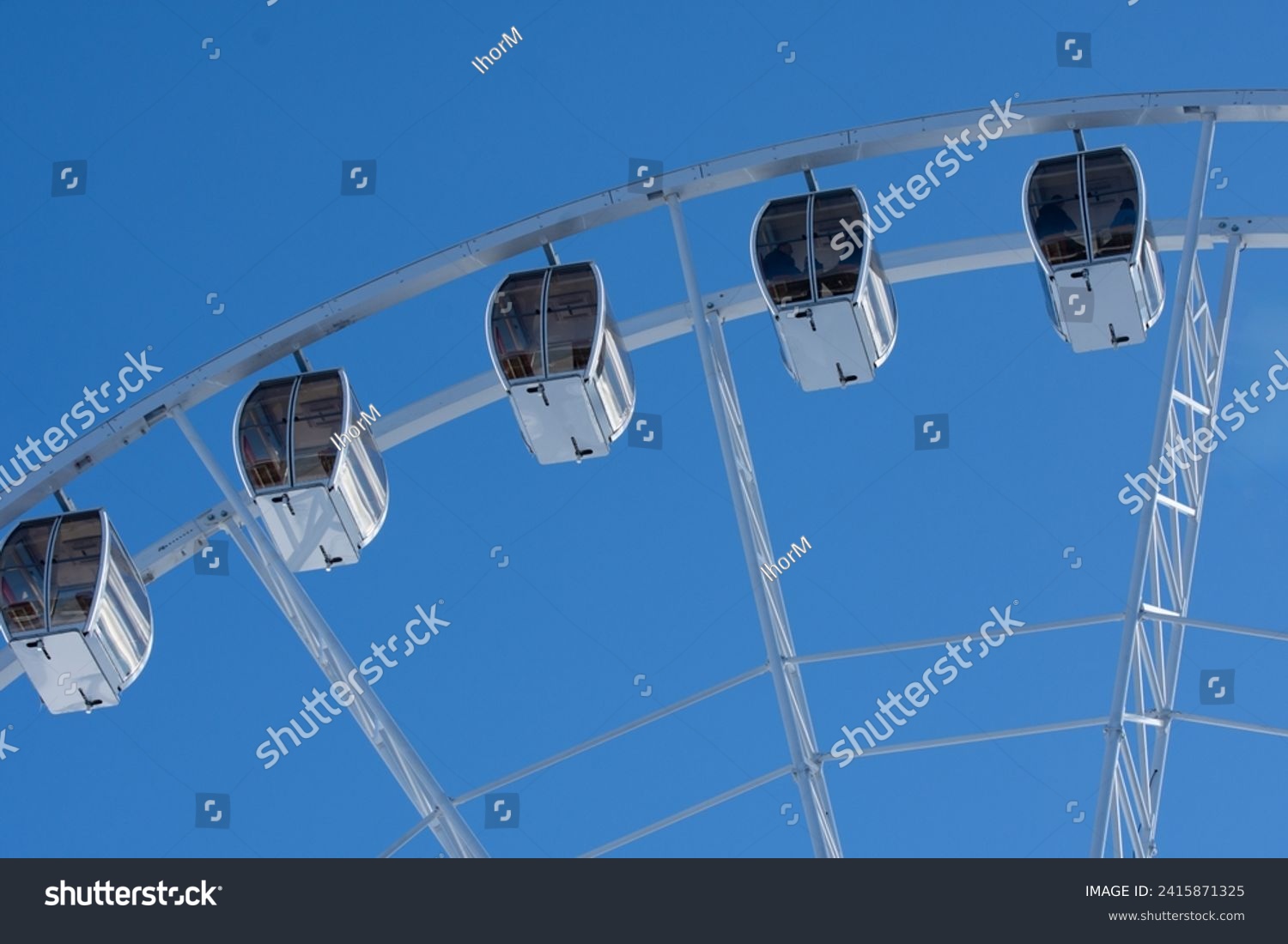 Ferris Wheel in publik park. Winter holidays in the Carpathians. Attraction in the recreational park in Bukovel.  #2415871325