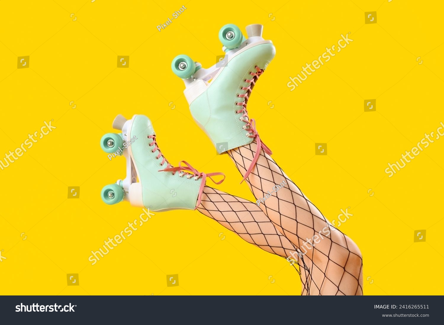 Legs of woman in roller skates on yellow background #2416265511