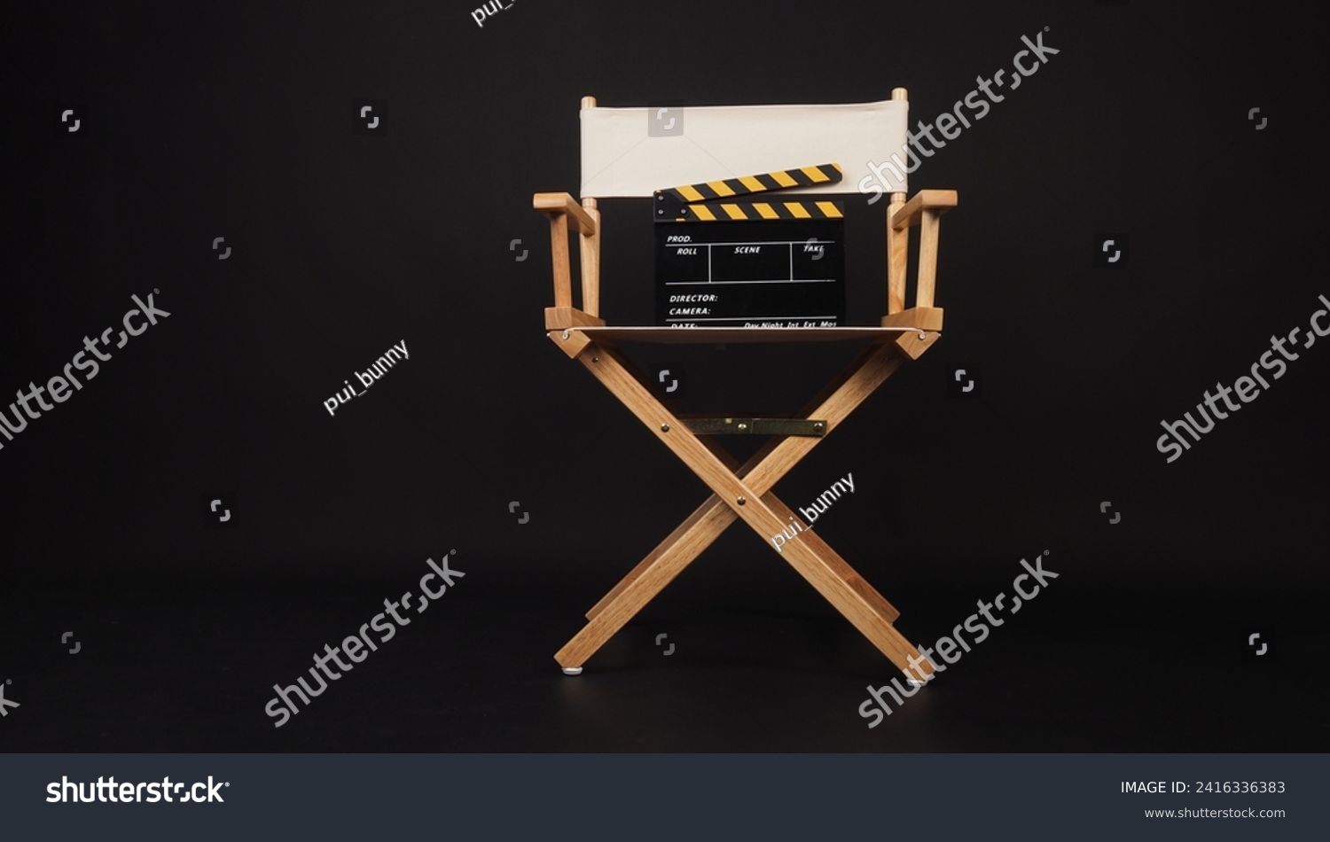 White director chair with clapper board on black background  #2416336383