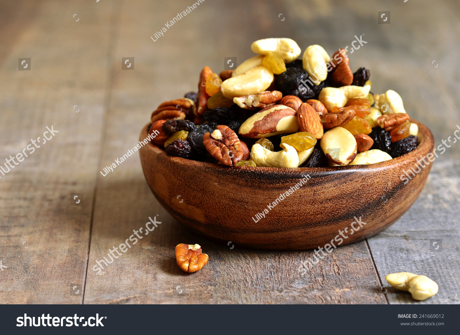 Dried fruits and nuts mix in a wooden bowl. #241669012