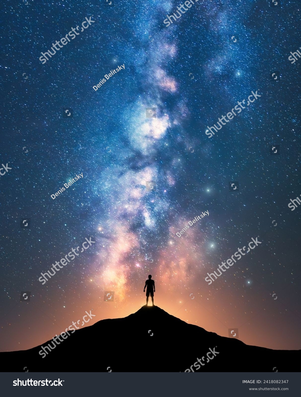 Milky Way and sporty man on mountain peak at starry night. Silhouette of a guy on the hill, sky with stars, yellow light in Nepal. Galaxy. Space landscape with bright milky way. Travel background #2418082347
