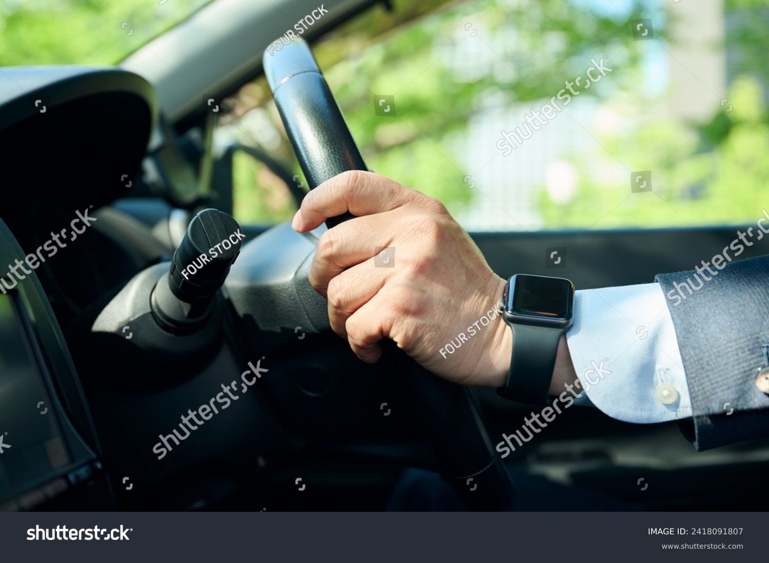 An office worker in his 50s gripping the steering wheel #2418091807