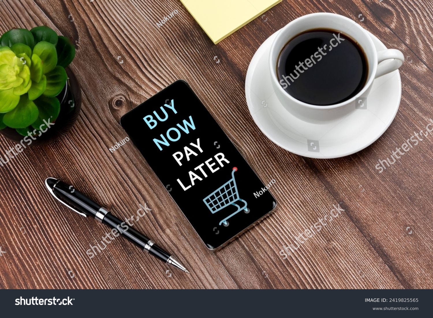 Buy now pay later shopping text on smart phone and cup of coffee #2419825565