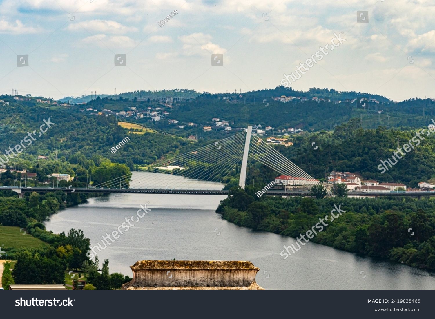 Scenery of Coimbra City in the summertime with the Mondego River and surrounding trees under a clear sky. Landscape background and wallpaper. #2419835465