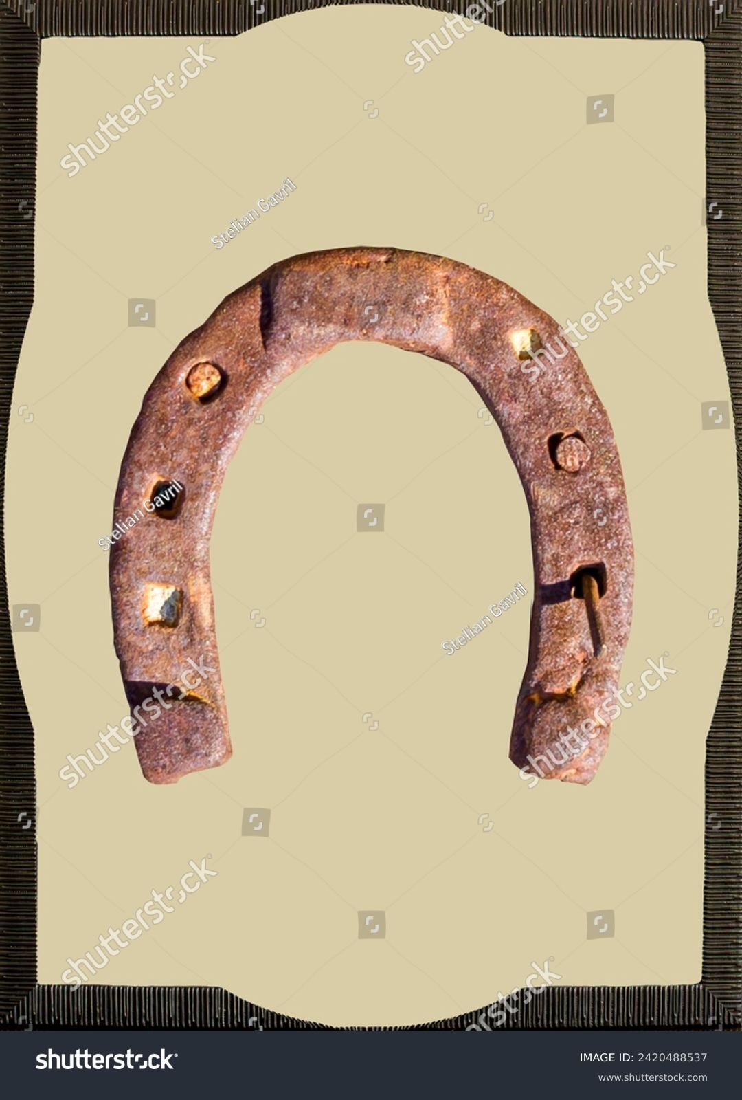 A framed horseshoe becomes a rustic art piece, emanating the strength and elegance of equestrian tradition. Wooden frames embrace the lucky symbol, offering an authentic and distinct appearance #2420488537