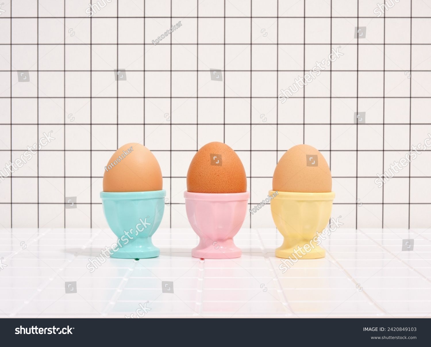 Three eggs in colorful stands. Healthy breakfast and diet. #2420849103