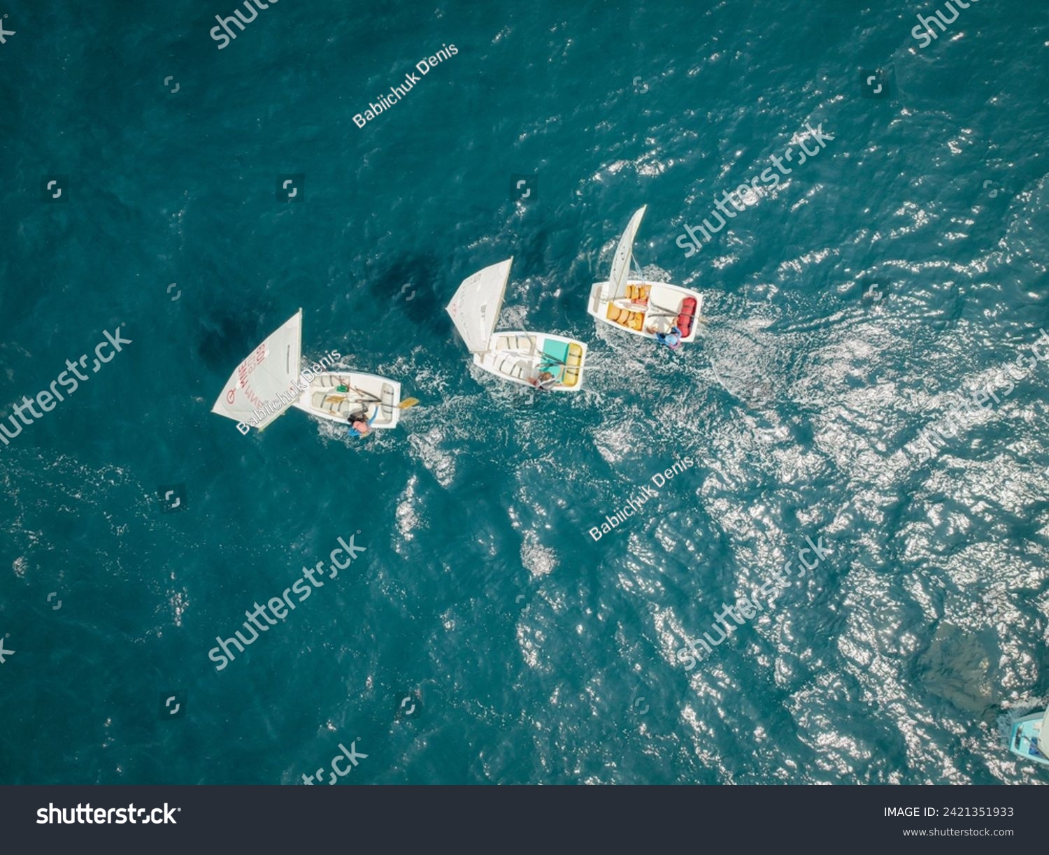 Aerial View of Small Sailboats Racing on Sea #2421351933