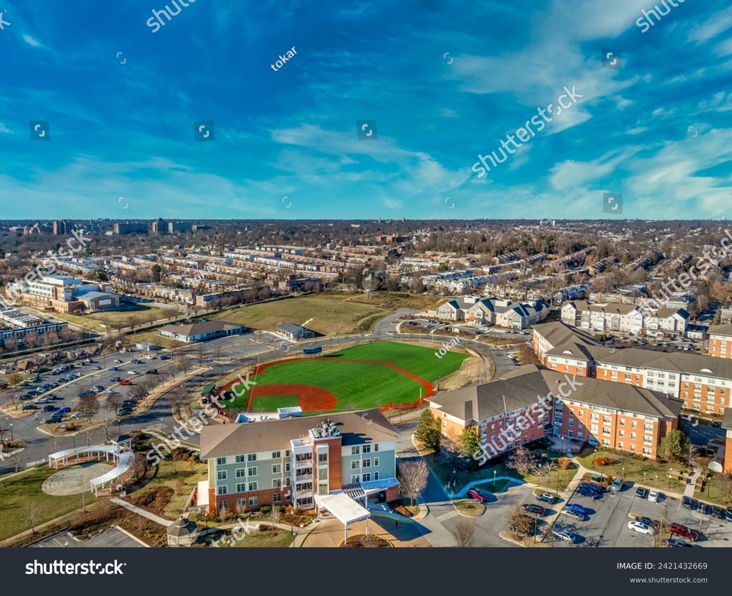 Aerial view of the former Memorial stadium redevelopment, now community recreational baseball field, mixed income senior residential complex, nursing center in Ednor gardens , Montebello Baltimore #2421432669