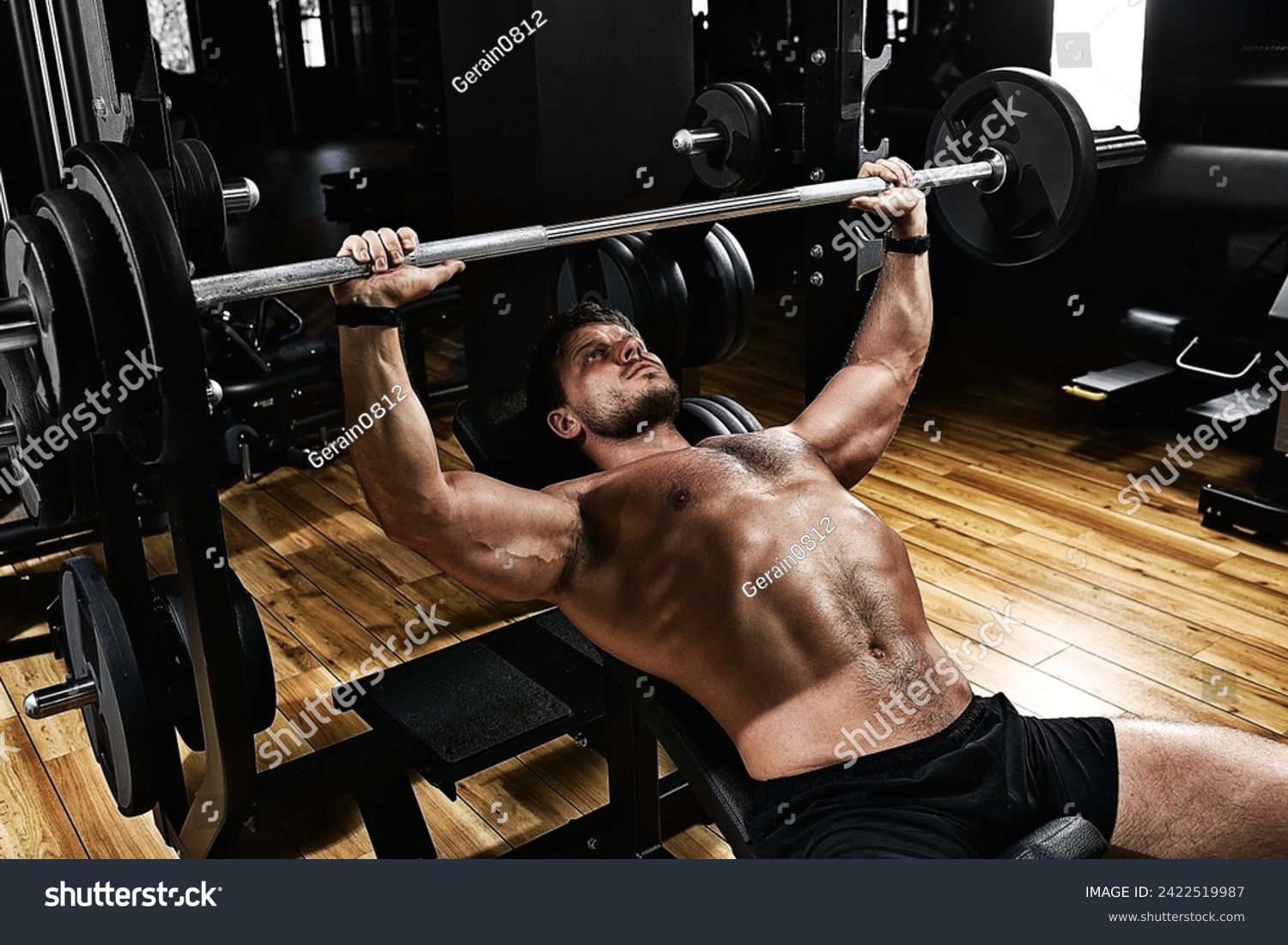 handsome young man doing bench press workout in gym, Fitness motivation, sports lifestyle, health, athletic body, body positive. Film grain, selective focus #2422519987