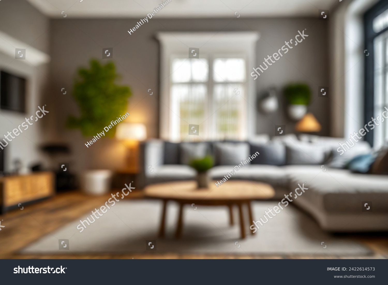 Blurred view of modern living room with sofa and soft bench. room interior with  couch, armchair and coffee table or shelving units. stylish living room. comfortable workplace near big window. #2422614573