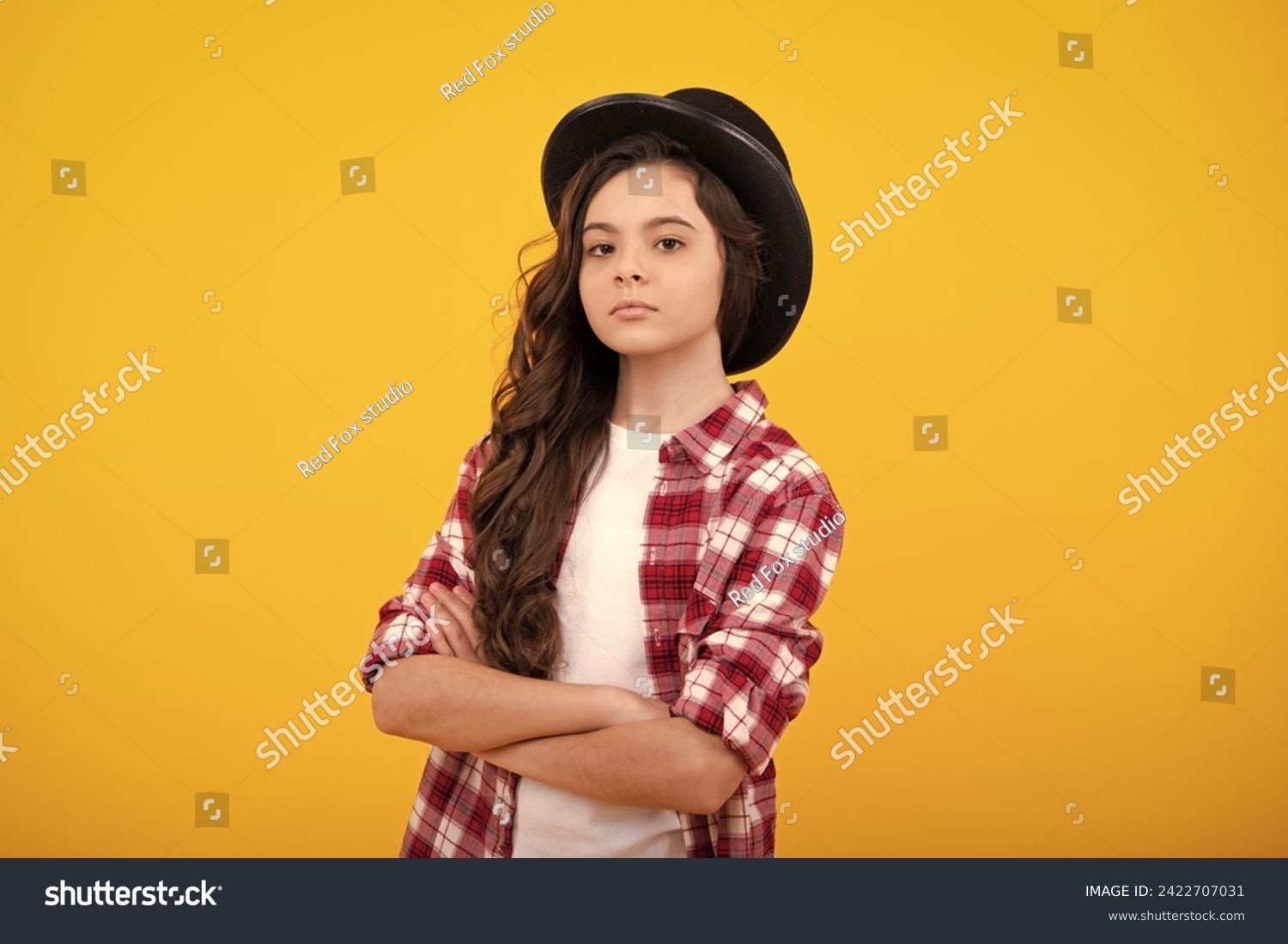 Child girl in magician hat, cylinder hat isolated on yellow background. Headwear. Clothes accessories. Fashion headwear for gentlemen in vintage style, old classic cylinder. #2422707031
