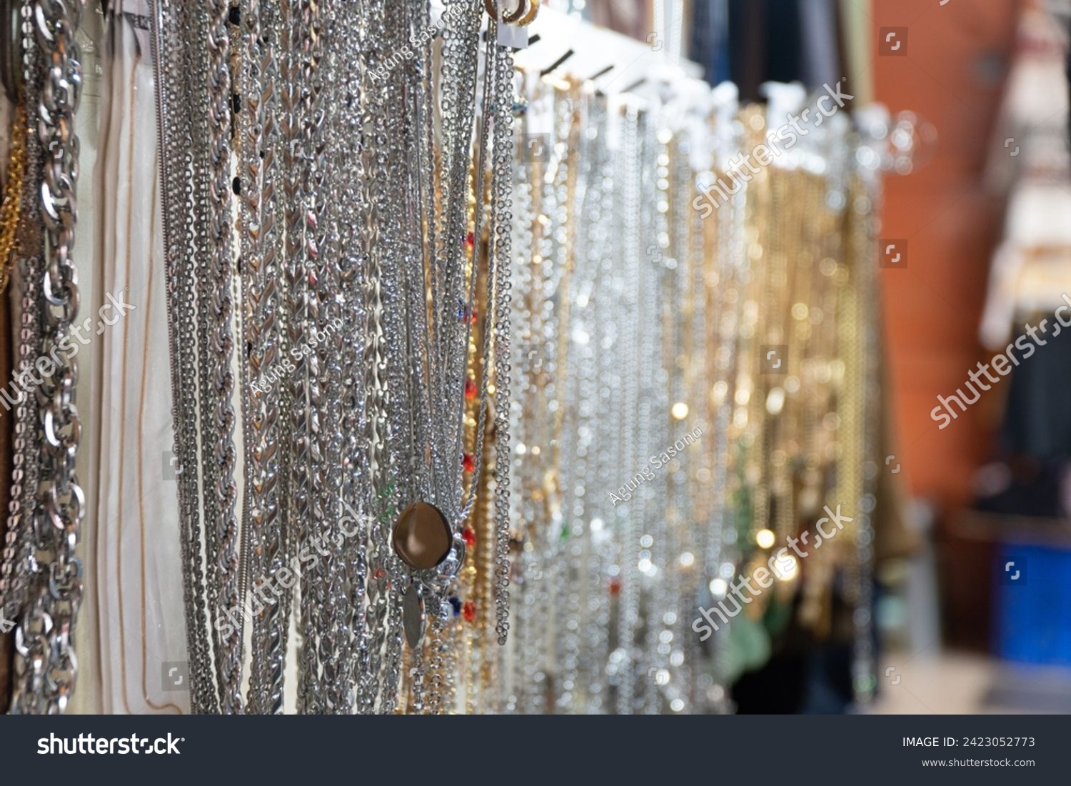 Steel necklace sold by street merchants on a busy sidewalk at Petak 6 street market #2423052773