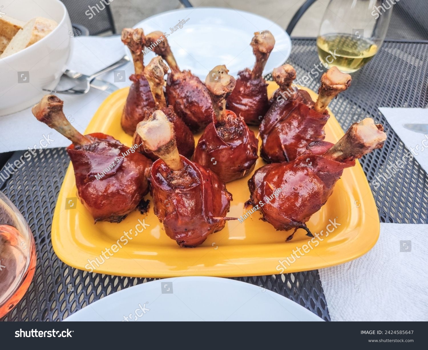 Chicken lollipop is a popular Indian fried chicken appetiser. Chicken lollipop is chicken winglet, wherein the meat is cut loose from the bone end and pushed down, creating a lollipop appearance. #2424585647