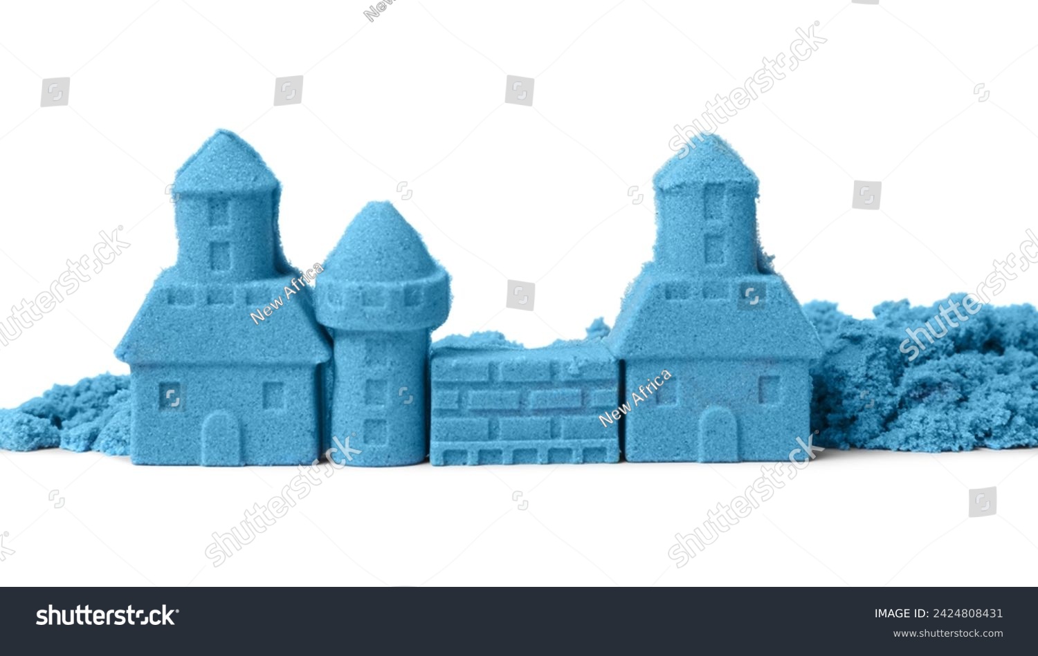 Castle made of blue kinetic sand isolated on white #2424808431