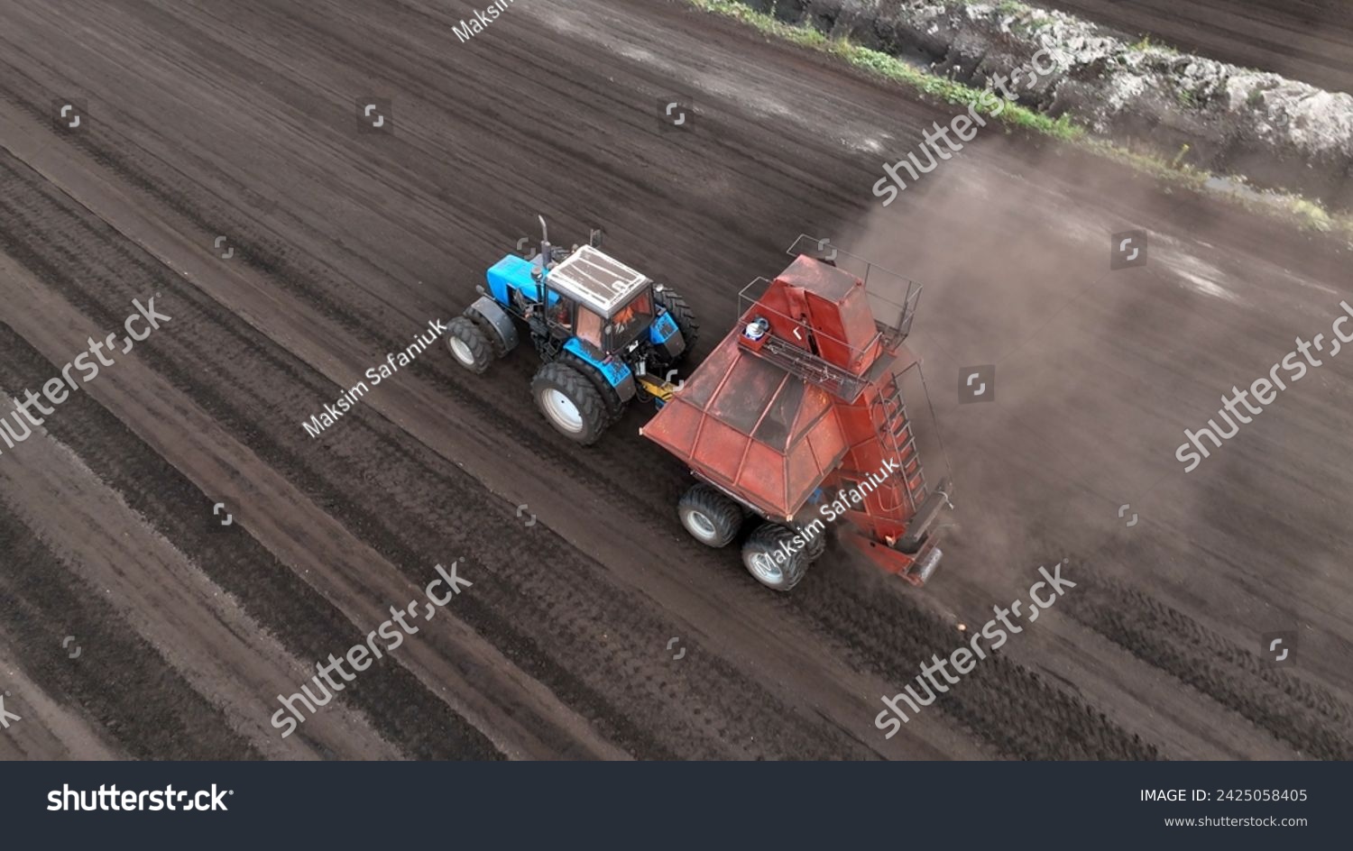 Peat Harvester Tractor on Collecting Extracting Peat. Mining and harvesting peatland. Area drained of the mire are used for peat extraction. Drainage and destruction of peat bogs. #2425058405