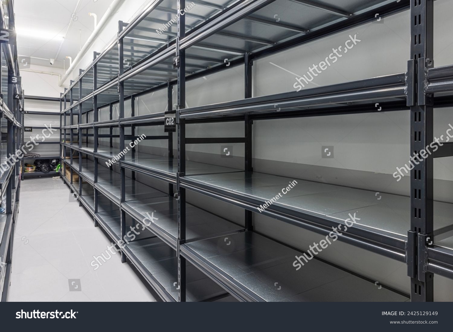 Warehouse racks storage metal pallet racking system in warehouse. Modern interior of new empty warehouse. The shelves are pallet racks. Metal structure. Storage equipment. #2425129149