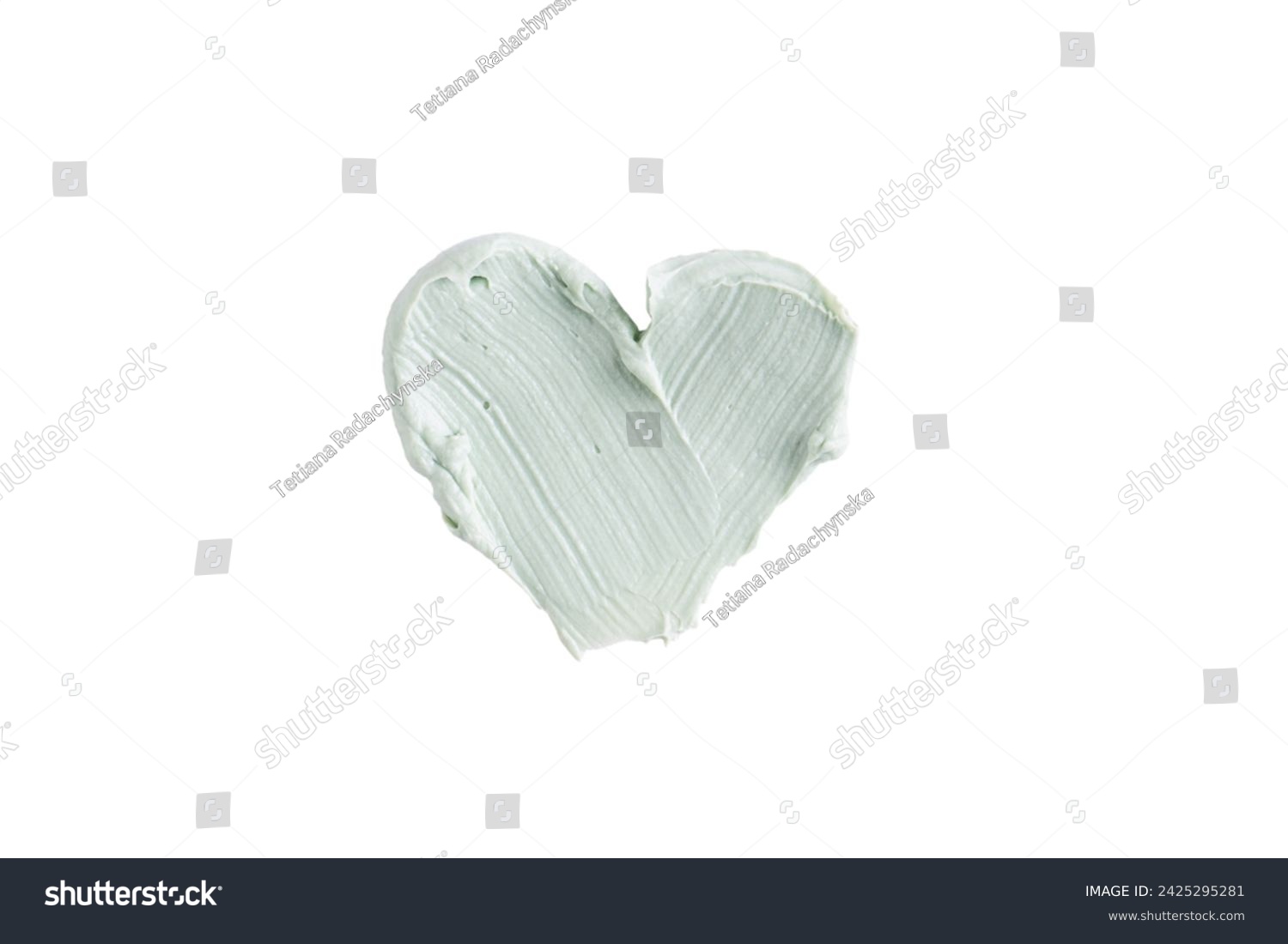 Green clay mask or correcting concealer smear smudge in the shape of a heart isolated on white background. Cream texture. Facial mask, skincare beauty product swatch closeup. SPA background #2425295281