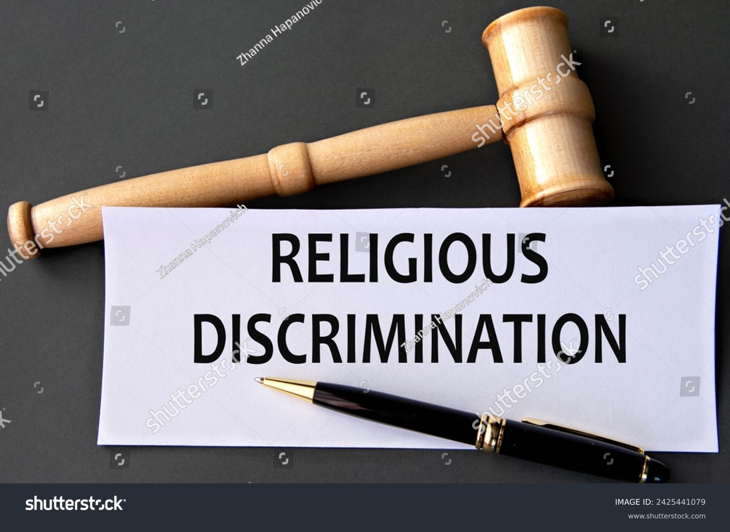 RELIGIOUS DISCRIMINATION - words on white paper on dark background with judge's gavel #2425441079